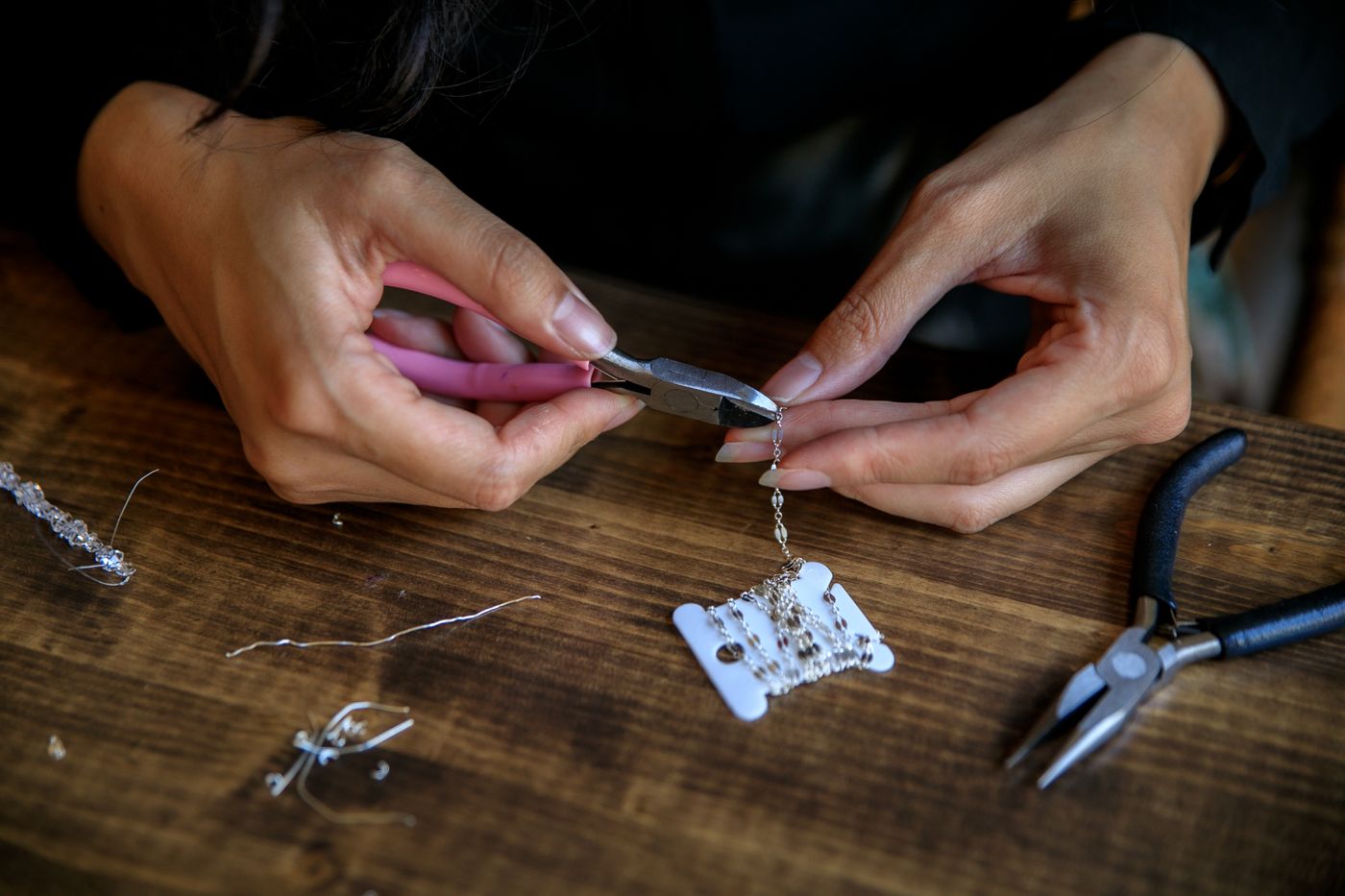 A jeweller setting a stone at the workbench